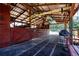 Barn interior with stall doors, open beams, and ample storage space, perfect for farm equipment and outdoor enthusiasts at 408 River Bed Ct, Wimauma, FL 33598