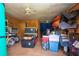 Barn interior with storage containers, a bicycle, and various equipment, illuminated by a ceiling fan at 408 River Bed Ct, Wimauma, FL 33598