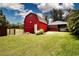Red barn on a well maintained lot with a paddock, perfect for equestrian enthusiasts and hobby farmers alike at 408 River Bed Ct, Wimauma, FL 33598