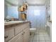 Cozy bathroom features a vanity with lots of cabinet space and shower with stylish curtain at 408 River Bed Ct, Wimauma, FL 33598