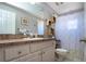 Well-lit bathroom features a vanity with lots of cabinet space and shower with stylish curtain at 408 River Bed Ct, Wimauma, FL 33598