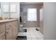Clean bathroom with vanity, tile floors and decorative wall hangings at 408 River Bed Ct, Wimauma, FL 33598