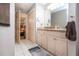 Bathroom with view to bedroom featuring a vanity with lots of cabinet space and tiled floor at 408 River Bed Ct, Wimauma, FL 33598