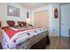 Bedroom with wood floors features a bed and closet at 408 River Bed Ct, Wimauma, FL 33598