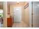 Inviting foyer featuring tile flooring and a classic wooden cabinet at 408 River Bed Ct, Wimauma, FL 33598