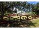 Charming single-story home with well-maintained lawn and decorative wooden fence at 408 River Bed Ct, Wimauma, FL 33598