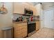 Kitchen features stainless steel appliances, including a range and overhead microwave oven at 408 River Bed Ct, Wimauma, FL 33598