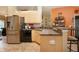 Bright kitchen featuring stainless steel appliances, breakfast bar and neutral toned cabinetry at 408 River Bed Ct, Wimauma, FL 33598