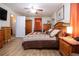 Spacious main bedroom with fan, warm wood tones and lots of room at 408 River Bed Ct, Wimauma, FL 33598