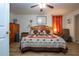 Cozy main bedroom features warm wood tones, ceiling fan and lots of light at 408 River Bed Ct, Wimauma, FL 33598