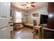 Comfortable office space features a desk, futon, and lots of light at 408 River Bed Ct, Wimauma, FL 33598