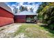 Barn with attached paddock, providing ample space for livestock and equipment storage on a well manicured lawn at 408 River Bed Ct, Wimauma, FL 33598
