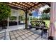 Charming covered patio with comfortable bench seating, perfect for enjoying the outdoors and relaxation at 408 River Bed Ct, Wimauma, FL 33598