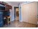 Room featuring wood floor, large closet, and doorway to the kitchen at 408 River Bed Ct, Wimauma, FL 33598