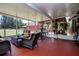 Spacious screened patio, perfect for entertaining, featuring comfortable wicker furniture and views of the backyard at 408 River Bed Ct, Wimauma, FL 33598