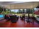 Spacious screened patio, perfect for entertaining, featuring outdoor furniture, high-top table and bar stools at 408 River Bed Ct, Wimauma, FL 33598