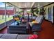 Spacious screened patio, perfect for entertaining, featuring comfortable wicker furniture and views of the backyard and barn at 408 River Bed Ct, Wimauma, FL 33598
