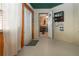 View of the sun room leading to the home's interior featuring a decorative sign, curtains and wood trimmed windows at 408 River Bed Ct, Wimauma, FL 33598