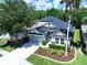 An aerial view of a residence displaying its surrounding greenery, well-kept lawn, and landscaping at 4116 Knollpoint Dr, Wesley Chapel, FL 33544