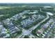 A scenic aerial view showcases a thriving residential community surrounded by verdant trees and landscaping at 4116 Knollpoint Dr, Wesley Chapel, FL 33544