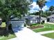 An aerial shot displaying a home with lush landscaping, mature trees, and a well-maintained lawn at 4116 Knollpoint Dr, Wesley Chapel, FL 33544