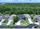 A beautiful aerial view of a well-maintained home and backyard with surrounding trees and landscaping at 4116 Knollpoint Dr, Wesley Chapel, FL 33544