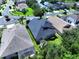 Backyard view of well-maintained grass lawn with lush landscaping and a screened lanai at 4116 Knollpoint Dr, Wesley Chapel, FL 33544