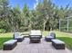 A welcoming outdoor patio setup with comfortable seating, perfect for relaxation and entertaining at 4116 Knollpoint Dr, Wesley Chapel, FL 33544