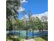 Community basketball court with fence around perimeter and sign posted to fence at 4116 Knollpoint Dr, Wesley Chapel, FL 33544