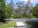 Community basketball court for residents to enjoy a friendly game with natural Florida landscaping around the court at 4116 Knollpoint Dr, Wesley Chapel, FL 33544
