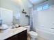 Bathroom features a vanity, toilet and shower-tub combo at 4116 Knollpoint Dr, Wesley Chapel, FL 33544