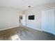 A neutral bedroom featuring wall mounted TV, standard closet, and an entry to another room at 4116 Knollpoint Dr, Wesley Chapel, FL 33544