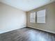 This bedroom features a hardwood floor and neutral wall colors at 4116 Knollpoint Dr, Wesley Chapel, FL 33544