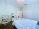 This bedroom includes a hanging chair, white bookshelf and view into the hall at 4116 Knollpoint Dr, Wesley Chapel, FL 33544