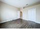 An empty bedroom with neutral walls and hardwood floors is ready for furnishings at 4116 Knollpoint Dr, Wesley Chapel, FL 33544