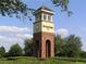 Landmark clock tower at Seven Oaks, featuring brick base, detailed trim, and community signage for a welcoming ambiance at 4116 Knollpoint Dr, Wesley Chapel, FL 33544