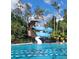Community pool featuring water slide, lounge chairs, and swimming lanes at 4116 Knollpoint Dr, Wesley Chapel, FL 33544