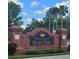 Community brick signage for The Club at Seven Oaks, enhanced by manicured landscaping at 4116 Knollpoint Dr, Wesley Chapel, FL 33544