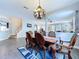 Dining room with hardwood floors and chandelier lighting at 4116 Knollpoint Dr, Wesley Chapel, FL 33544