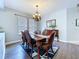 Well-lit dining room with hardwood floors and a classic chandelier at 4116 Knollpoint Dr, Wesley Chapel, FL 33544