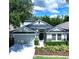 Charming two-story home with a well-manicured lawn, a two car garage, and a welcoming front porch at 4116 Knollpoint Dr, Wesley Chapel, FL 33544