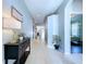 Hallway with tile floors, decorations, and neutral paint at 4116 Knollpoint Dr, Wesley Chapel, FL 33544