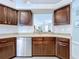 Functional kitchen offering wooden cabinets, stainless steel appliances, and a view into other rooms at 4116 Knollpoint Dr, Wesley Chapel, FL 33544