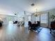 Open-concept living and dining area with hardwood floors, recessed lighting, and lots of natural light at 4116 Knollpoint Dr, Wesley Chapel, FL 33544