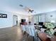 Bright living room featuring hardwood floors, a ceiling fan, and access to the outdoors at 4116 Knollpoint Dr, Wesley Chapel, FL 33544