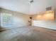 Open loft area with carpet and plenty of natural light at 4116 Knollpoint Dr, Wesley Chapel, FL 33544