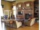 Lounge area featuring a fireplace, bookshelves, hardwood floors, and comfortable seating at 4116 Knollpoint Dr, Wesley Chapel, FL 33544