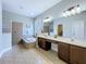 Spacious main bathroom with double sinks, bathtub, and a separate shower at 4116 Knollpoint Dr, Wesley Chapel, FL 33544