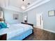 Light-filled primary bedroom with tray ceilings, walk-in closets and ensuite bathroom at 4116 Knollpoint Dr, Wesley Chapel, FL 33544