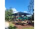 Community playground with multiple tables and chairs for families at 4116 Knollpoint Dr, Wesley Chapel, FL 33544